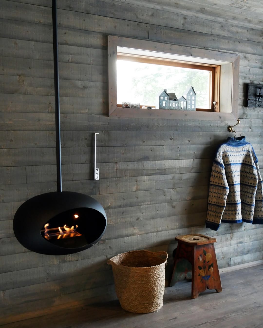 Le Feu fireplace adding warmth and ambiance to a rustic chalet interior, perfect for cozy cabin living.