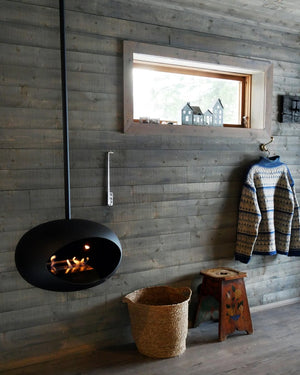 Le Feu fireplace adding warmth and ambiance to a rustic chalet interior, perfect for cozy cabin living.